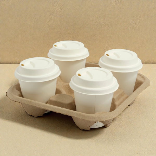 Four disposable coffee cups with lids in a cardboard holder on a beige background