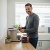 Man making a mahalia coffee blend 4 pod using a pod coffee machine in a kitchen.