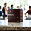 Box of 'blend no. 4' European dark roast coffee on a table with people in the background